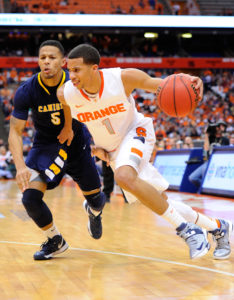 Syracuse Orange guard Michael Carter-Williams (1) drives to the basket around Canisius Golden Griffins guard Reggie Groves (5) during the second half at the Carrier Dome. (Photo by Rich Barnes-USA TODAY Sports)