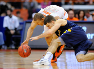 Billy Baron and Syracuse Orange guard Brandon Triche (20) battle for a loose ball during the second half at the Carrier Dome. Syracuse defeated Canisius 85-61. (Photo by Rich Barnes-USA TODAY Sports)