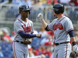 Atlanta Braves center fielder B.J. Upton (2) is congratulated by Atlanta Braves first baseman Chris Johnson (23) after scoring a run during the sixth inning at Nationals Park.  (Photo by Brad Mills-USA TODAY Sports)