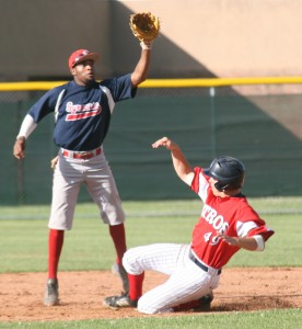 Wellsville's Alec Bahnick (49) slides safely into second base as Syracuse's Bud Morton awaits the throw from home plate during Wednesday's NYCBL playoff game in Wellsville. PAUL A. JANNACE/Daily Reporter