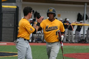 Angel Rosario greeted at home by teammate Brett Sanders. (Photo courtesy of Monroe CC Athletics). 