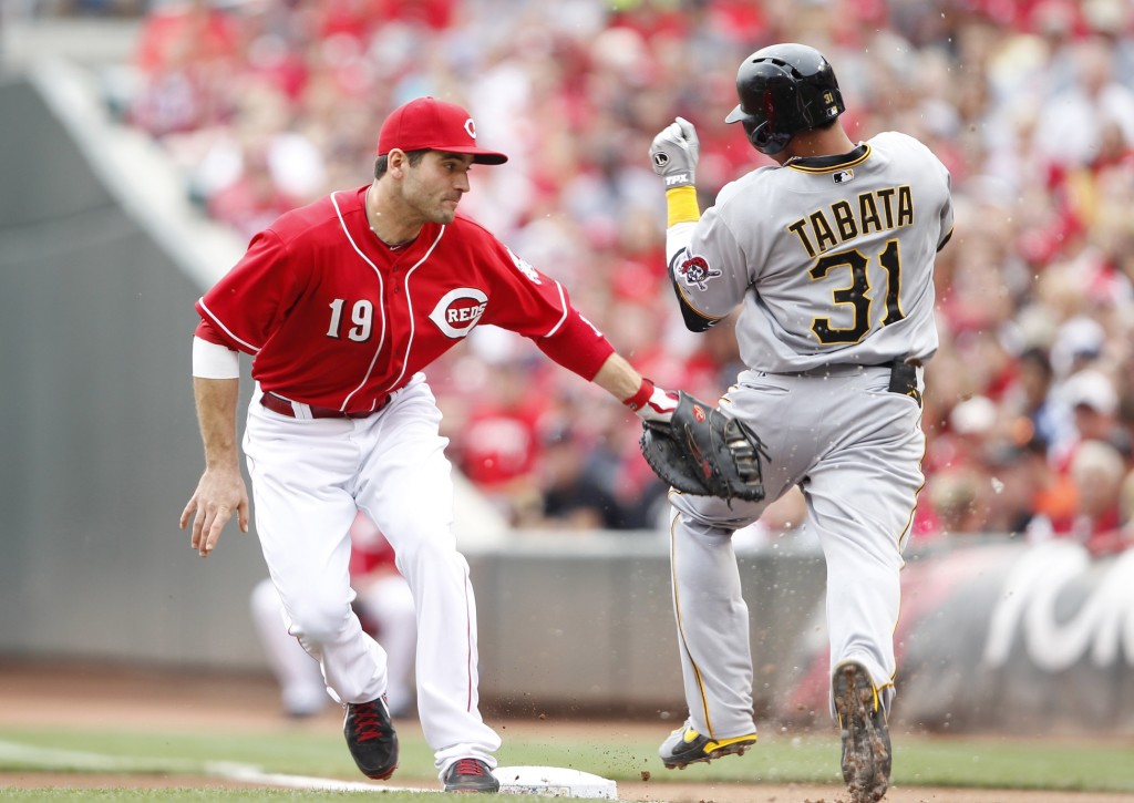  Cincinnati Reds first baseman Joey Votto (19) attempts a tag on the Pittsburgh Pirates right fielder Jose Tabata (31) during the first inning at Great American Ball Park. (Photo by Frank Victores-USA TODAY Sports)