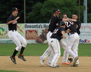 Oneonta Outlaw teammates mug #26 Kody Ruedisili after his two-RBI hit in the bottom of the 10th inning gave the Outlaws a come from behind 6-5 win and a five game sweep of the Cortland Crush at Damaschke Field, Sunday night. (By Brian Horey a/k/aBRIANthe PHOTOguy)