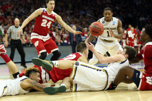 Demtrius Jackson (11) looks on as several players dive on the floor for a loose ball. (Photo: Bill Streicher-USA TODAY Sports)