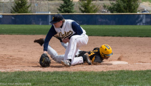 Christian Palawek (14) slides in safely at first ahead of the tag. (Photo: SUE KANE)