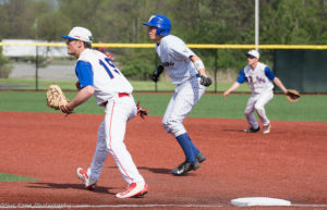 Justin Graham gets a lead off first base while Fairport's Evan Newark (19) and Chad Riorden (17) look on. (Photo: SUE KANE)