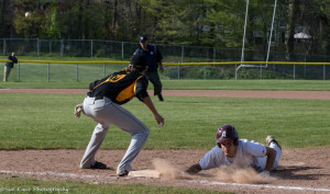 Johnny Mason slides in ahead of the pickoff attempt at first base. Morrie Silver (10) covers the bag for McQuaid. (Photo: SUE KANE)