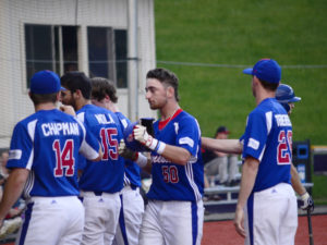 Grant Myers (Monmouth College) enters the dugout after his RBI double and crossing the plate as the tying run.