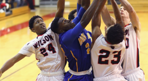 Players battle for a rebound during Tuesday's non-league game. Irondequoit beat Wilson, (Photo:Ron Kalasinskas)