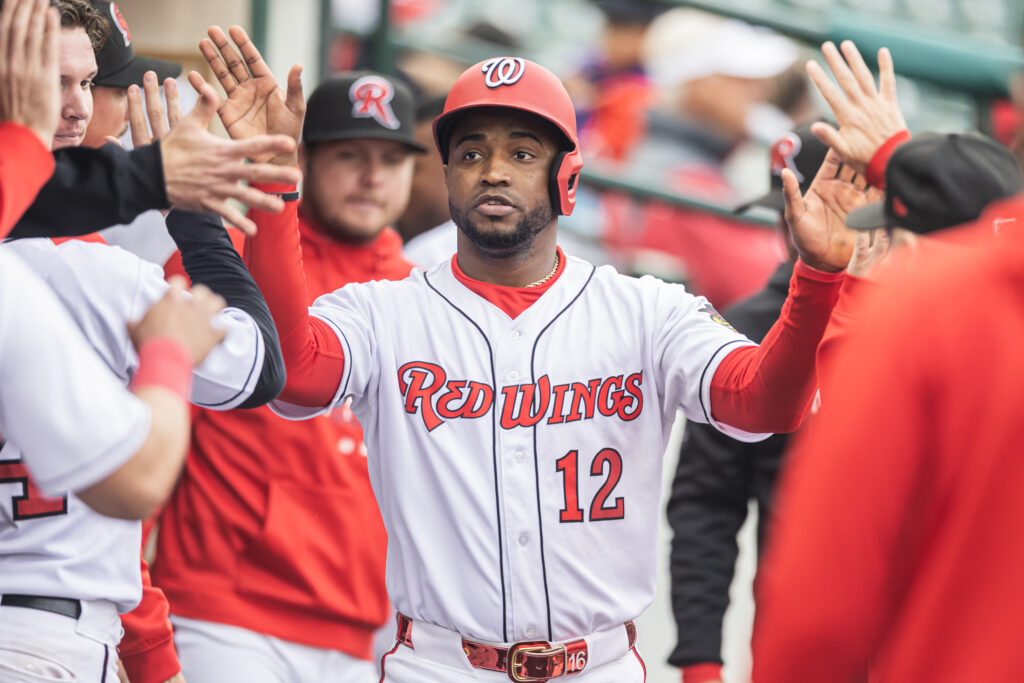 Victor Robles gets high-fives after scoring during the Red Wings' loss on Tuesday. The outfielder is in Rochester on a rehab assignment. (CREDIT: Rochester Red Wings/Ethan Bissinger)