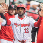 Victor Robles gets high-fives after scoring during the Red Wings' loss on Tuesday. The outfielder is in Rochester on a rehab assignment. (CREDIT: Rochester Red Wings/Ethan Bissinger)