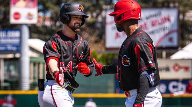 Jackson Cluff gets a high-five from Victor Robles after hitting his first AAA home run on Thursday. (CREDIT: Rochester Red Wings/Allison Lyons)